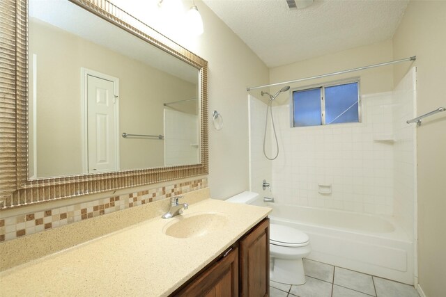 full bathroom with toilet, tiled shower / bath, a textured ceiling, vanity, and tile patterned flooring