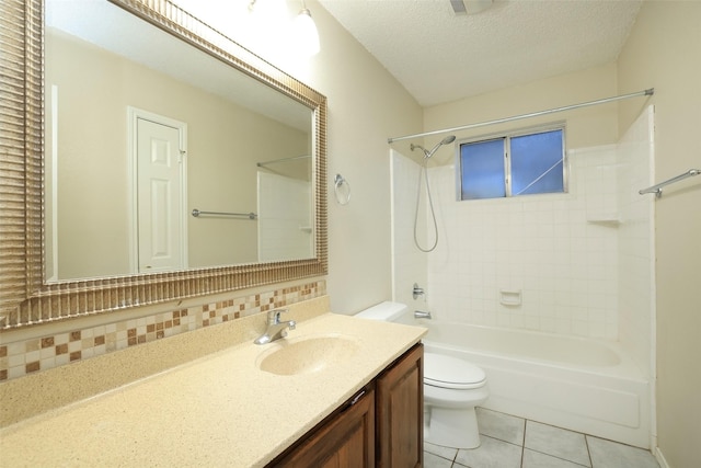 full bathroom featuring tiled shower / bath combo, vanity, toilet, tile patterned floors, and a textured ceiling