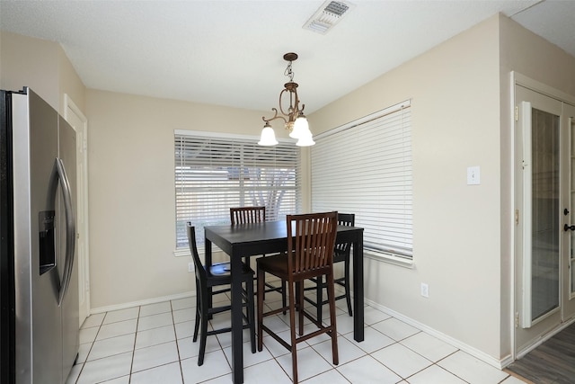 9130 Kirkleigh St, Spring, TX 77379 - dining area featuring a chandelier, baseboards, and light tile patterned floors