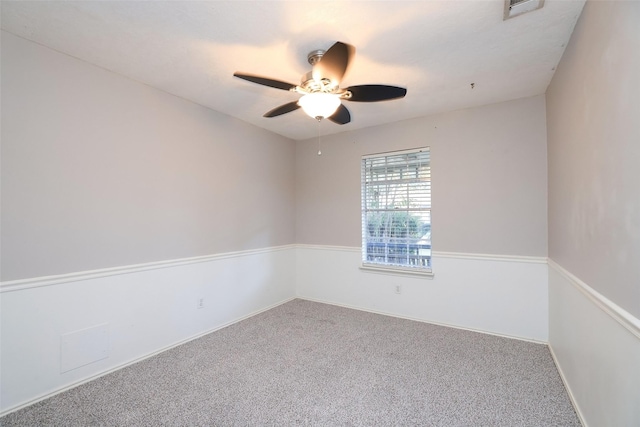 unfurnished room with ceiling fan and carpet flooring