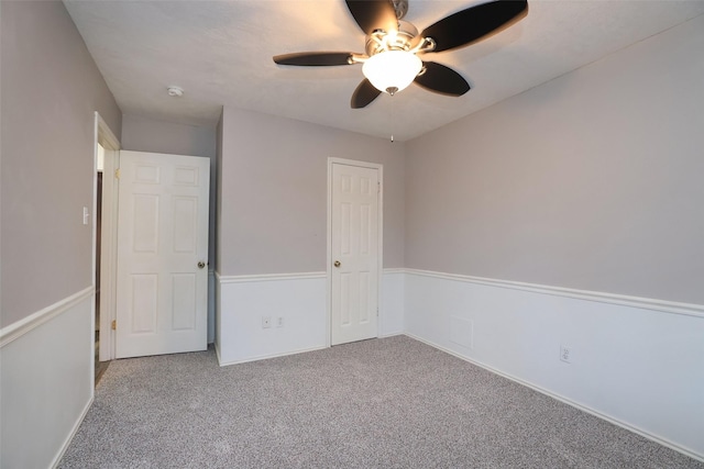 unfurnished bedroom featuring carpet floors, a closet, and ceiling fan