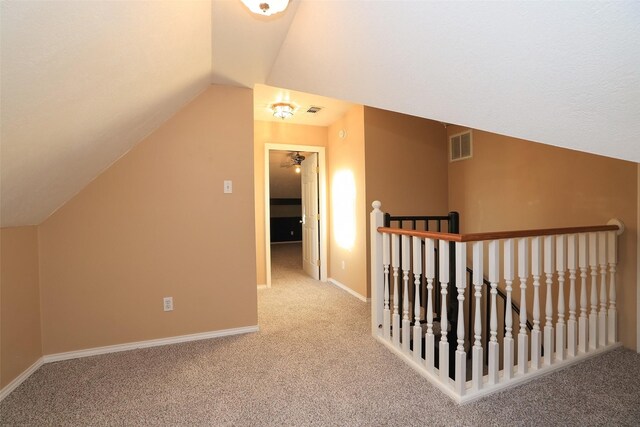 bonus room with carpet floors and vaulted ceiling