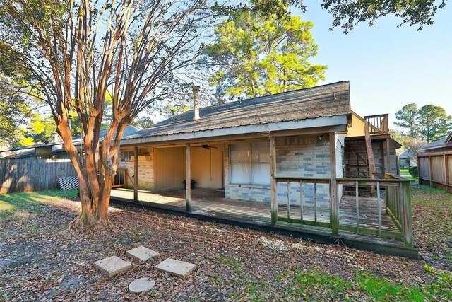 back of property with a wooden deck