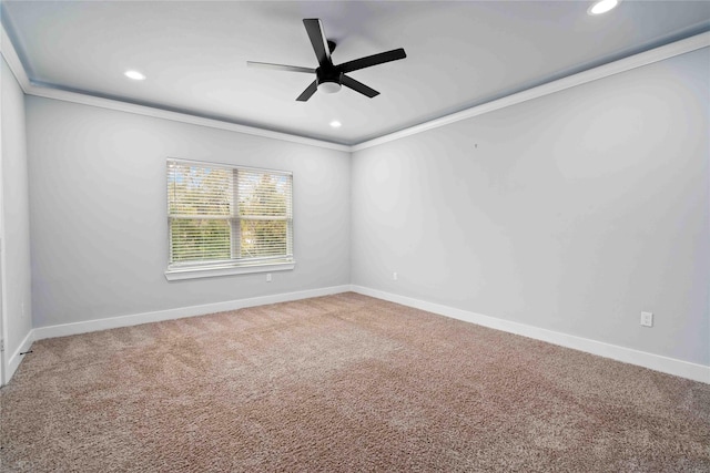 carpeted spare room featuring ceiling fan and ornamental molding