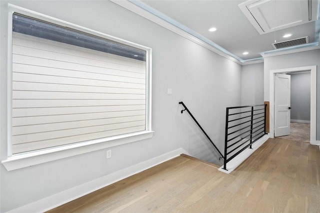 staircase featuring hardwood / wood-style flooring and ornamental molding