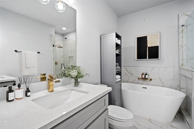 full bathroom featuring toilet, vanity, separate shower and tub, and tile walls