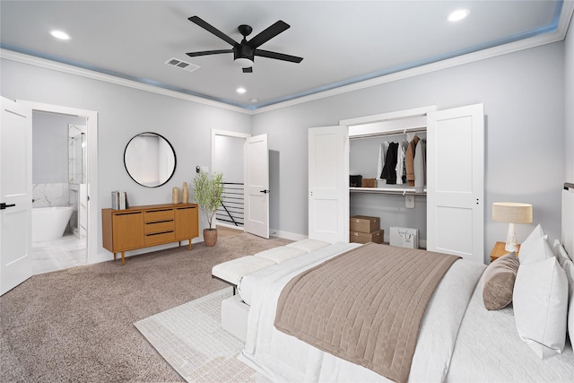 carpeted bedroom with ceiling fan, ensuite bathroom, crown molding, and a closet