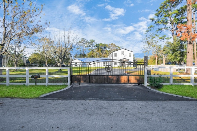 view of gate featuring a lawn