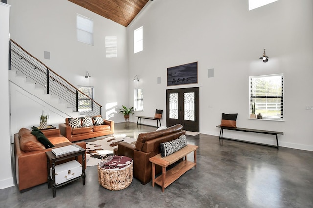 living room featuring wood ceiling, a high ceiling, and french doors