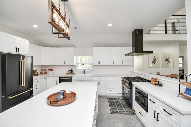 kitchen featuring white cabinets, premium appliances, island range hood, and sink