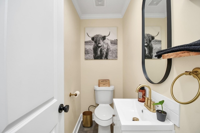 bathroom with vanity, toilet, and ornamental molding