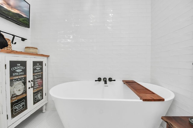 bathroom featuring a bathing tub and tile patterned flooring