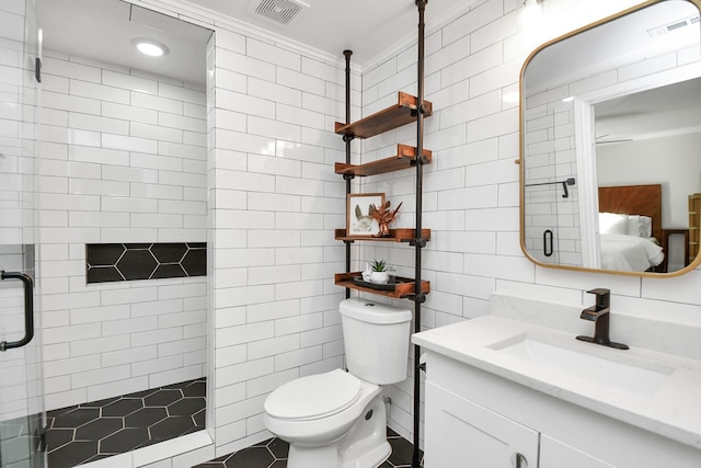 bathroom featuring walk in shower, vanity, toilet, and tile walls