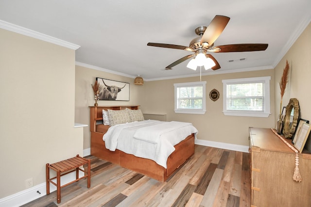 bedroom featuring light hardwood / wood-style flooring, ceiling fan, and crown molding