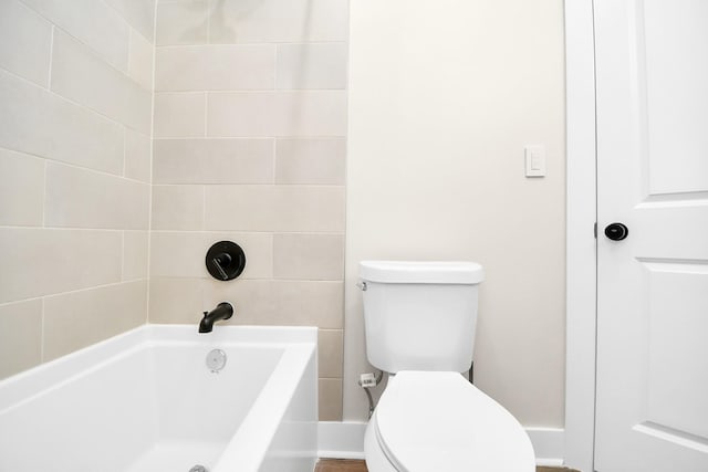 bathroom featuring toilet and a bath