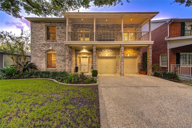 view of front of property with a yard, a balcony, and a garage