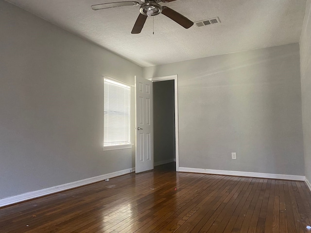 spare room featuring a textured ceiling, ceiling fan, and dark hardwood / wood-style floors