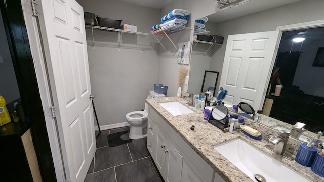 bathroom featuring tile patterned floors, vanity, and toilet