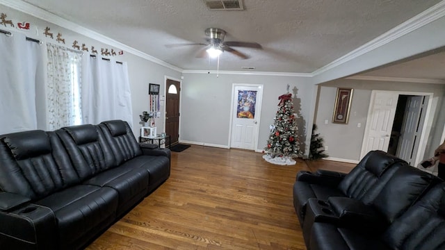 living room with crown molding, ceiling fan, a textured ceiling, and hardwood / wood-style flooring