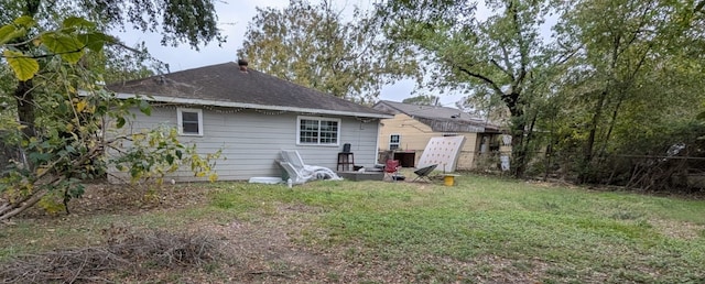 back of property with a lawn