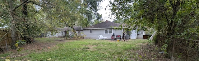 rear view of property with a lawn