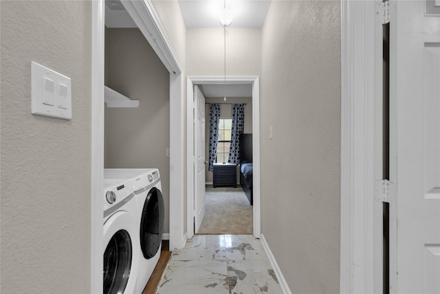 clothes washing area with washer and clothes dryer and light colored carpet