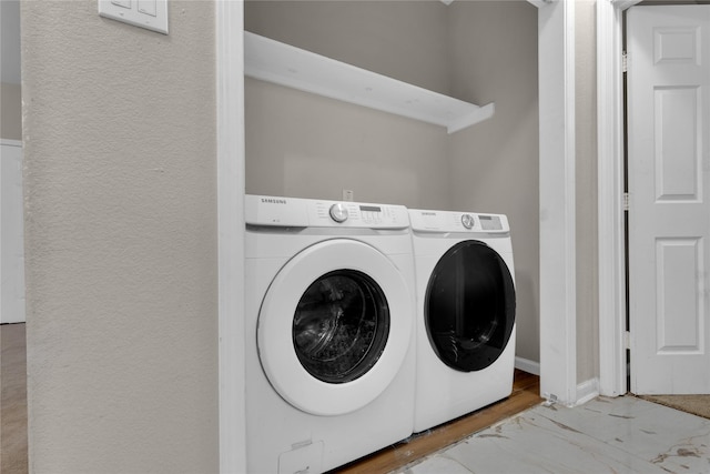 laundry room featuring washing machine and clothes dryer