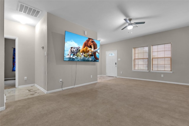 unfurnished living room featuring ceiling fan and light colored carpet