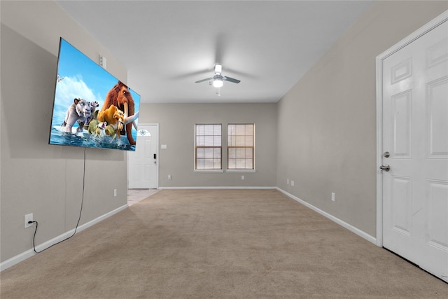 unfurnished living room featuring light colored carpet and ceiling fan