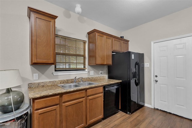 kitchen featuring dark hardwood / wood-style flooring, sink, and black appliances