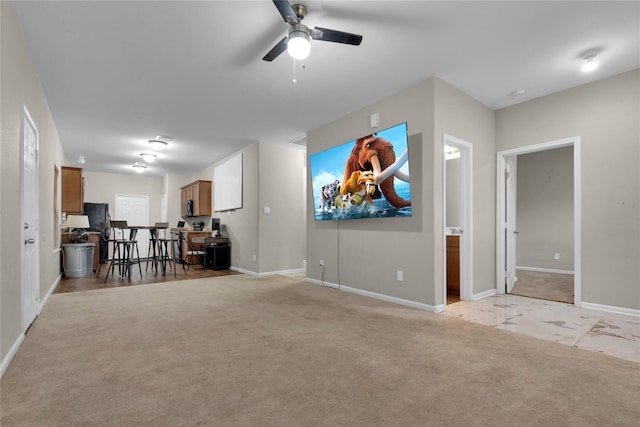 living room featuring ceiling fan and light carpet