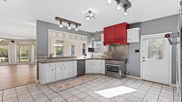 kitchen featuring white cabinetry, stainless steel appliances, a wealth of natural light, and tasteful backsplash