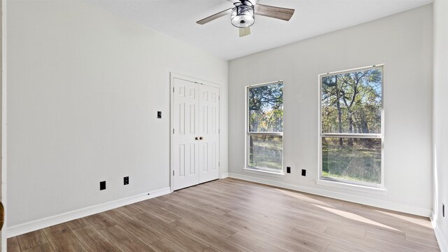 spare room featuring ceiling fan and light wood-type flooring