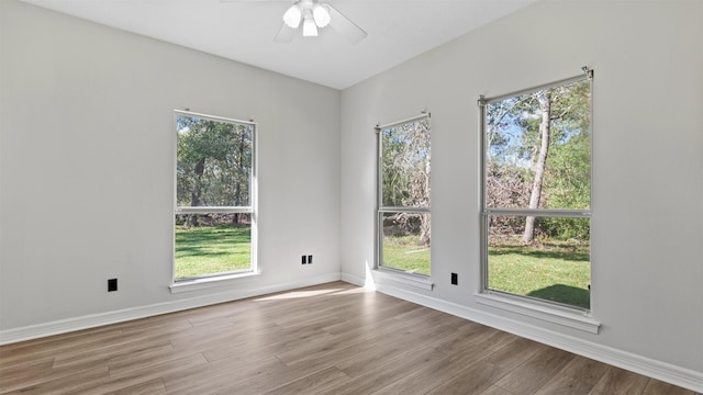 unfurnished room featuring a wealth of natural light and hardwood / wood-style flooring