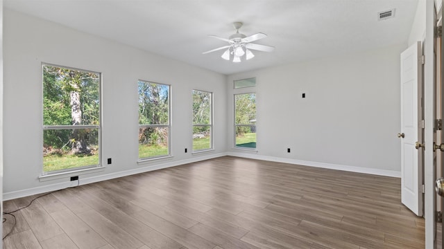 empty room with hardwood / wood-style flooring and ceiling fan