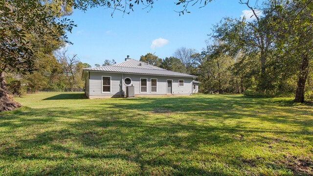 rear view of house with a yard