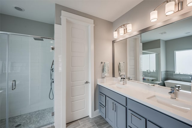 bathroom with separate shower and tub and vanity