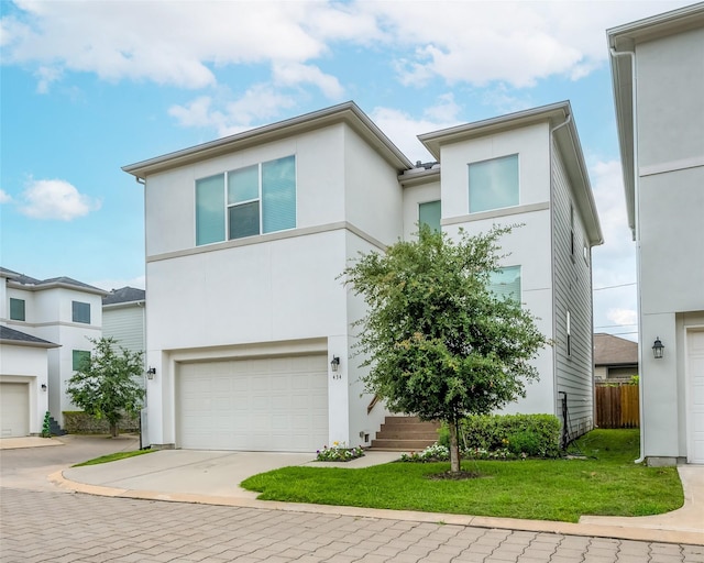 view of front of house with a garage and a front lawn