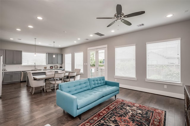 living room featuring ceiling fan, dark hardwood / wood-style flooring, french doors, and sink