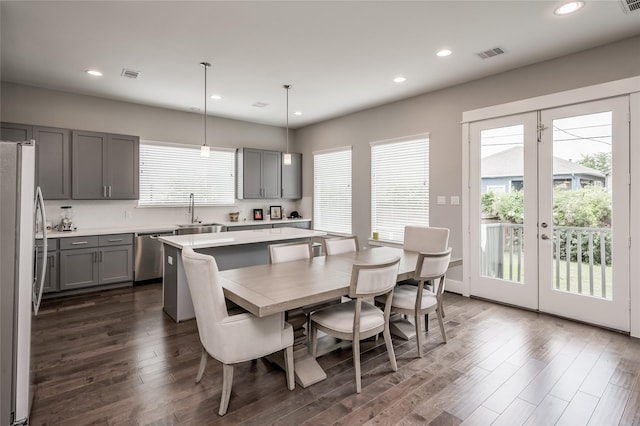 dining room featuring french doors, dark wood-type flooring, and sink