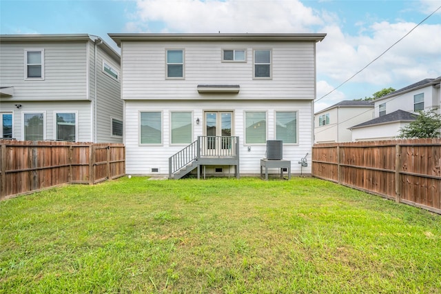 rear view of property with a yard and cooling unit