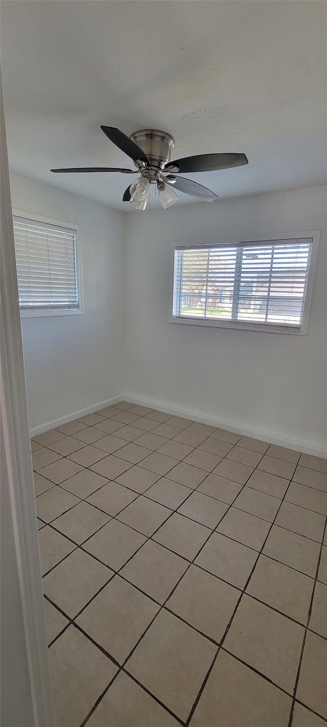 empty room featuring ceiling fan and light tile patterned floors