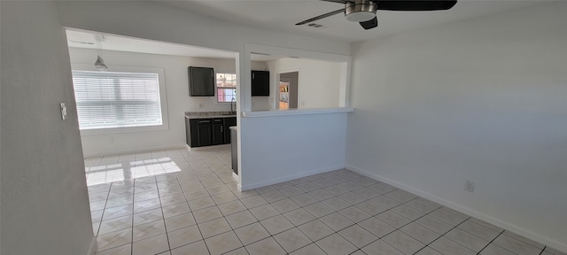 kitchen with ceiling fan, light tile patterned floors, and sink