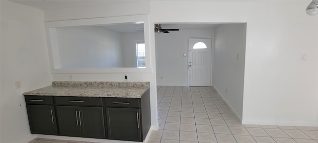 interior space featuring light tile patterned floors and ceiling fan