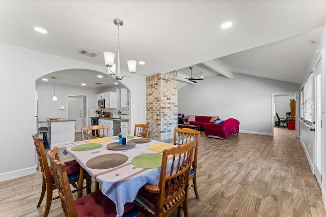 dining room featuring light hardwood / wood-style floors, lofted ceiling with beams, and ceiling fan with notable chandelier