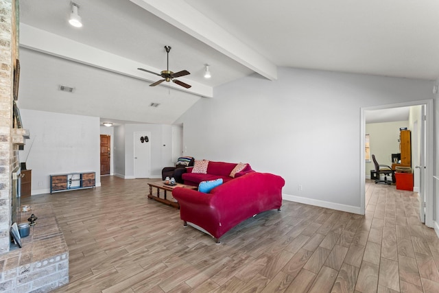 living room with ceiling fan and lofted ceiling with beams