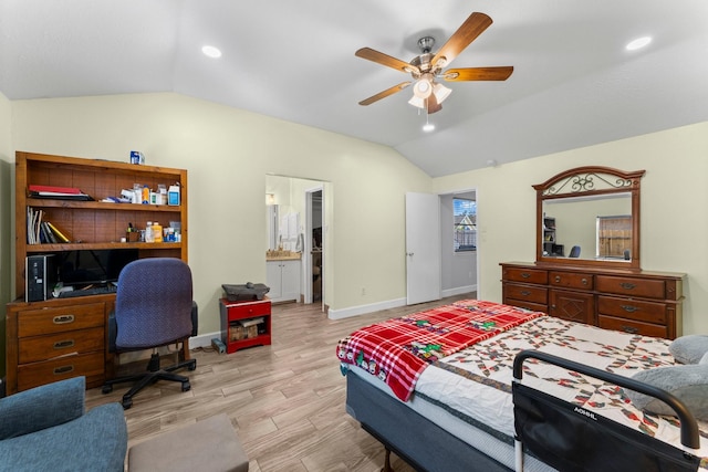 bedroom featuring ceiling fan, lofted ceiling, light hardwood / wood-style floors, and ensuite bath