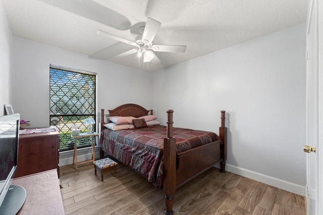 bedroom with ceiling fan and light hardwood / wood-style flooring