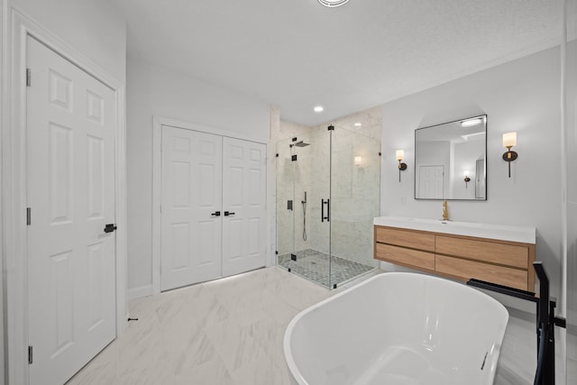 bathroom with vanity, a textured ceiling, and plus walk in shower