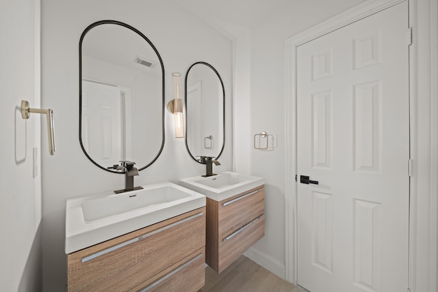 bathroom featuring vanity and hardwood / wood-style flooring